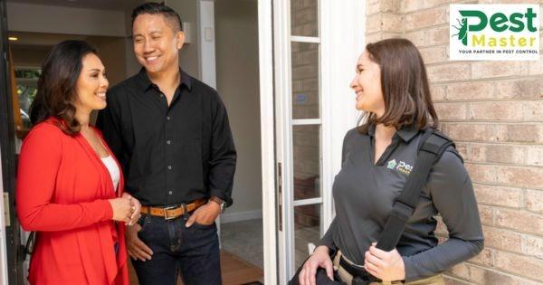 Franchise candidate meeting PestMaster representative at home discussing recession-resistant franchise