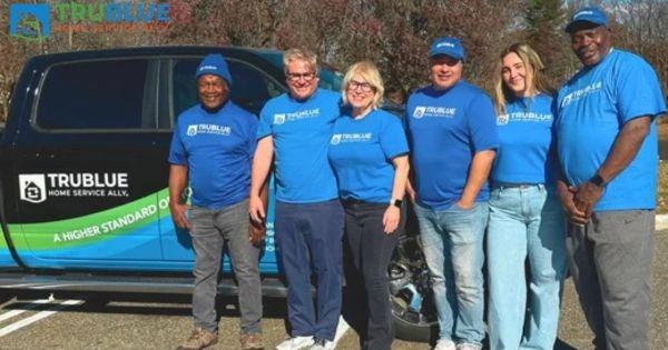 TruBlue Home Service Ally team with branded service vehicle, highlighting senior home services and franchise business opportunity