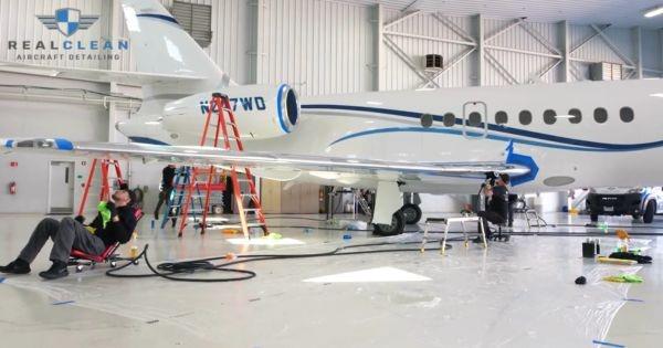 RealClean aircraft detailing team servicing private jet in hangar, supporting new Louisville KY franchise expansion