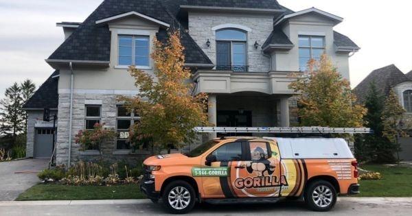 Gorilla Property Services branded truck parked at upscale Austin home, highlighting exterior cleaning and franchise expansion