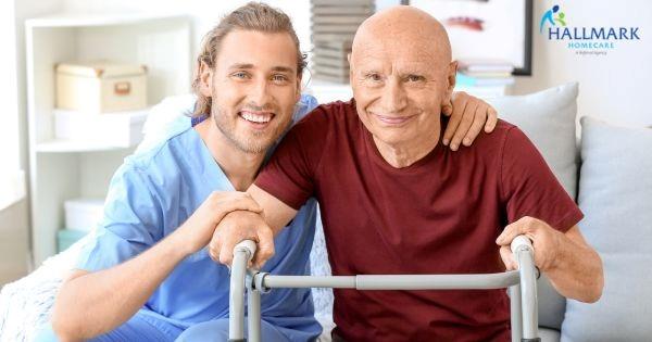 Hallmark Homecare caregiver assisting senior with walker at home, representing in-home care franchise expansion in NC