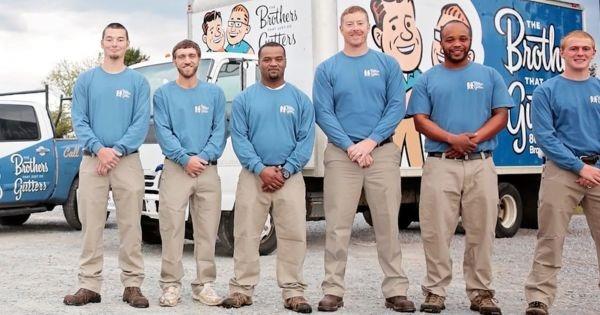 Brothers Gutters team standing in uniform beside branded truck, showcasing professional gutter service franchise expansion