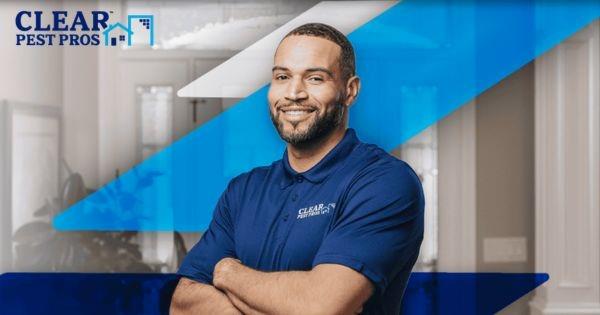 Clear Pest Pros technician in uniform inside home, representing residential pest control services and franchise opportunity