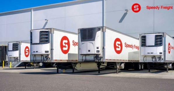 Speedy Freight trailers at logistics warehouse, highlighting Jacksonville FL freight and transportation franchise expansion