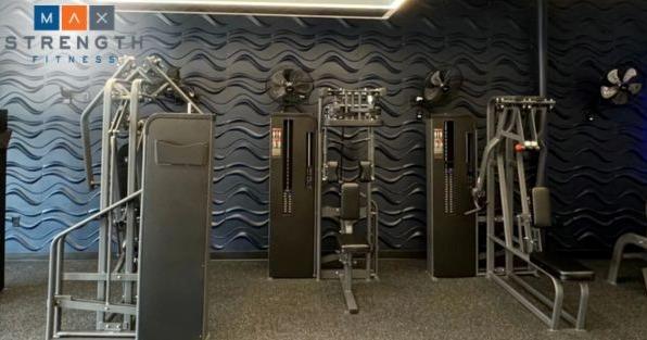 MaxStrength Fitness franchise gym with strength training equipment, highlighting premium personal fitness coaching
