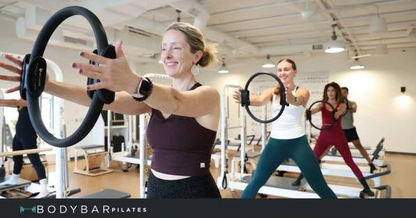 BODYBAR Pilates franchise class using reformer equipment, highlighting boutique fitness and wellness in Charlotte