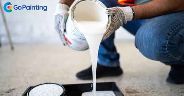 Go Painting franchise painter pouring paint, highlighting commercial painting services and B2B franchise opportunity