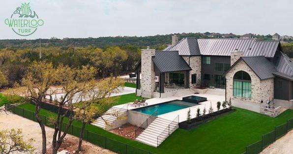 Waterloo Turf franchise artificial grass installation at luxury home, highlighting premium synthetic turf landscaping
