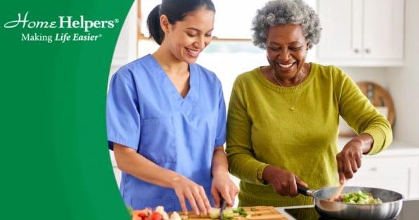 Home Helpers Home Care franchise caregiver preparing a meal with senior, highlighting in-home senior care services