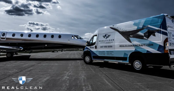 RealClean franchise aircraft detailing service van beside private jet, highlighting mobile aircraft cleaning services