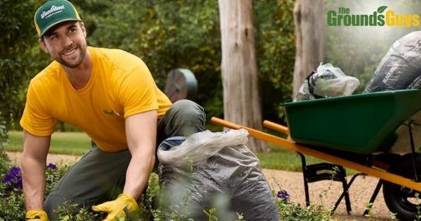 The Grounds Guys franchise lawn care professional providing landscaping services, highlighting professional property maintenance