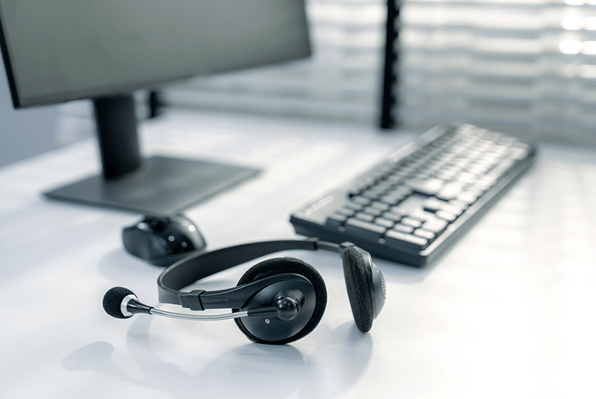 Headset and keyboard at an IFPG call center desk for franchise broker leads
