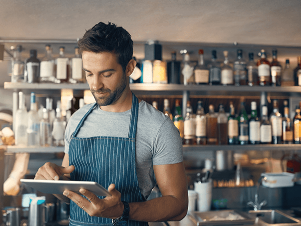 Franchise owner using a tablet at his business